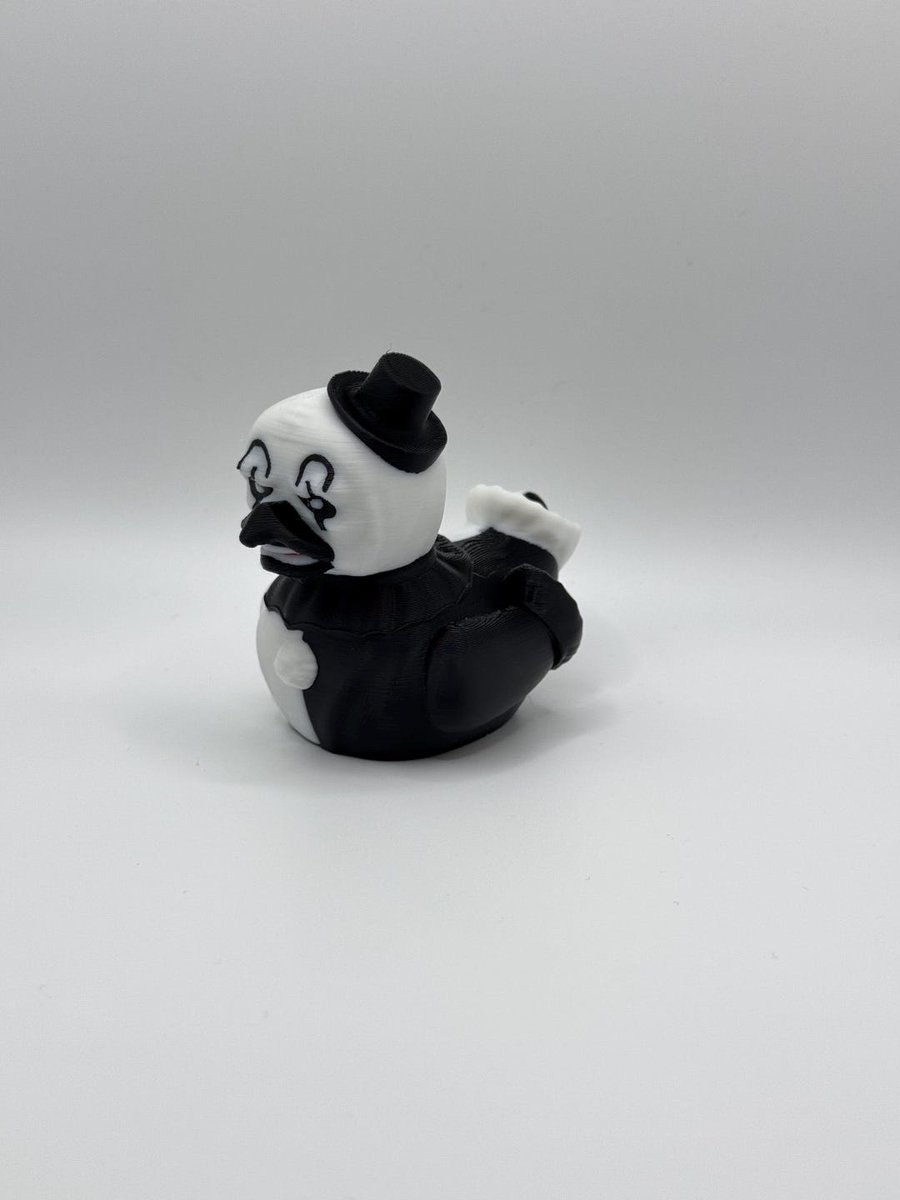 Black-and-white clown-themed duck collectible